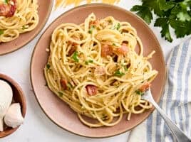 Overhead view of a plate of spaghetti carbonara with a fork.