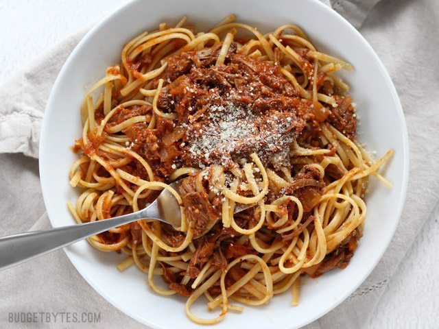 Sunday slow cooker beef ragu served in a bowl with a fork.