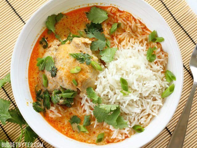 Thai coconut curry braised chicken thighs in a dish.