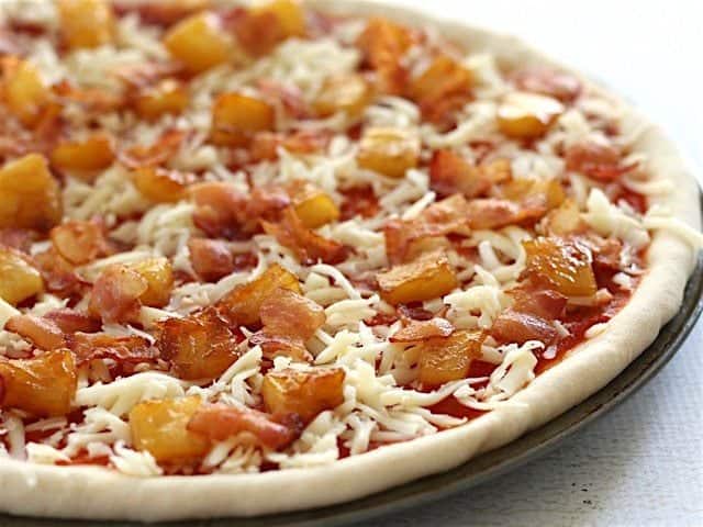 Sideview of uncooked bacon pizza