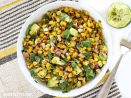 Warm Corn and Avocado Salad makes the perfect light and fresh side for enchiladas, grilled meats, or tacos. BudgetBytes.com