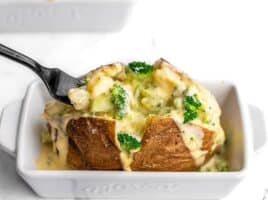 A fork digging into a broccoli cheddar stuffed potato