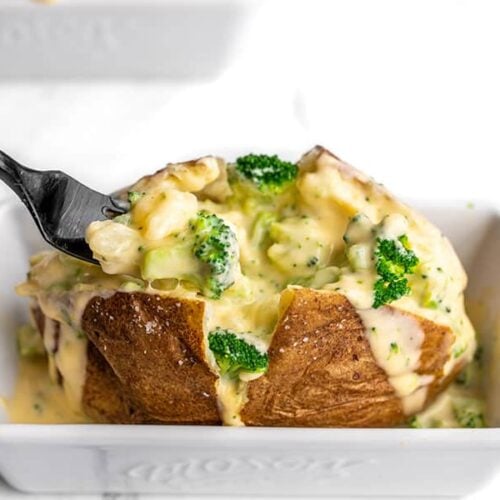 A fork digging into a broccoli cheddar stuffed potato