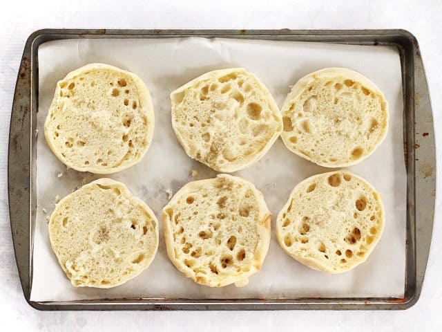 Naked English Muffins on a parchment lined baking sheet