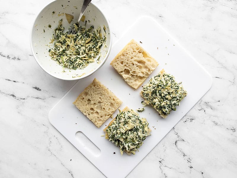 Spinach artichoke filling added to pieces of focaccia