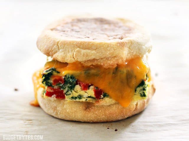 Baked freezer-ready breakfast sandwiches on a plate.