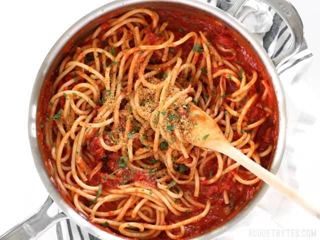 Finished Pasta with 5 Ingredient Butter Tomato Sauce in the skillet, some pasta twirled around a wooden pasta fork.