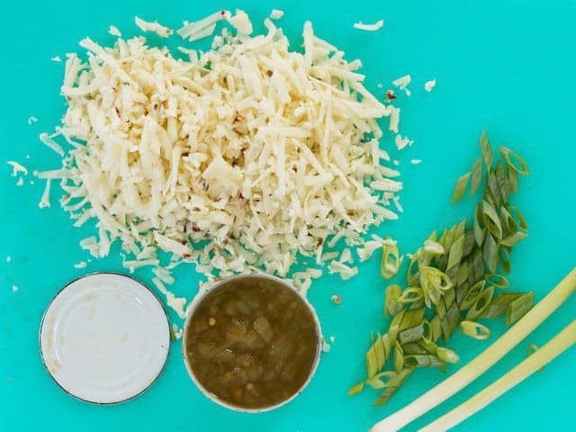 Shredded pepper jack, a can of green chiles, and sliced green onions