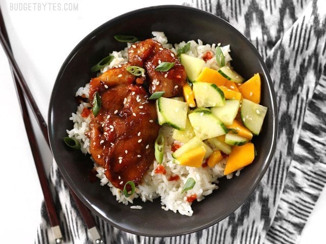 Sticky Ginger Soy Glazed Chicken in a bowl with jasmine rice and cucumber mango salad