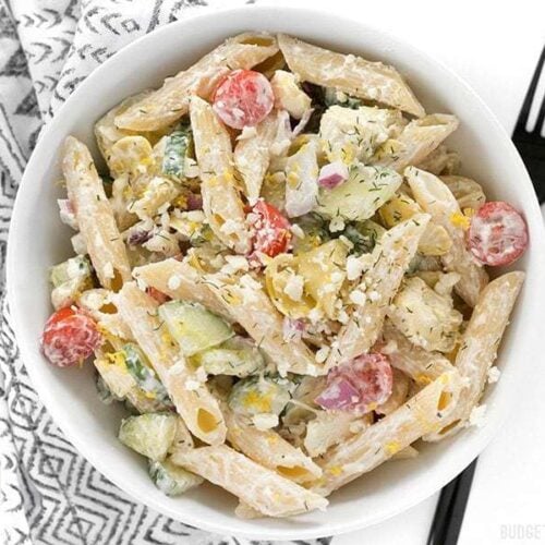 Creamy Greek pasta salad served in a bowl with a fork.