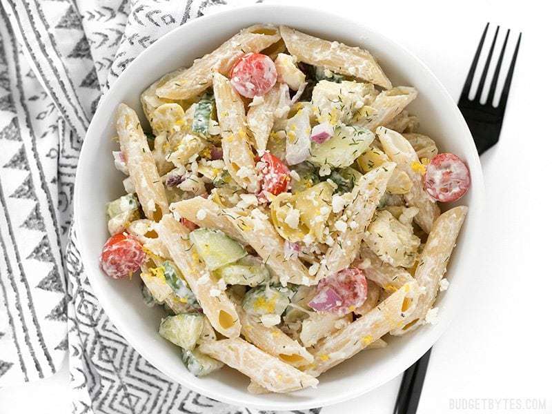 Creamy Greek pasta salad served in a bowl with a fork.