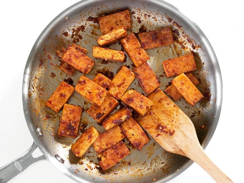 Add Chili Garlic Sauce to fried tofu in skillet