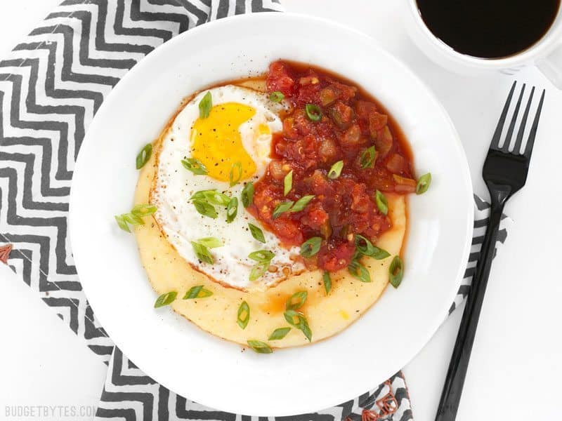 Cheddar grits breakfast bowl served with toppings.