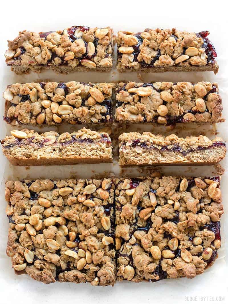 Peanut Butter and Jelly Bars cut from the slab, two turned sideways to make the layers visible.