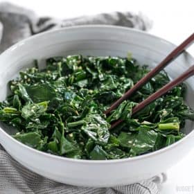 Sesame kale sticks arranged on a plate.