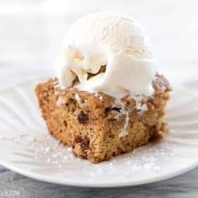 Applesauce cake served with a scoop of ice cream.