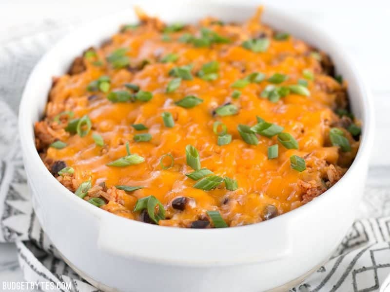 Front view of Beef Burrito Casserole in the casserole dish, topped with sliced green onions.