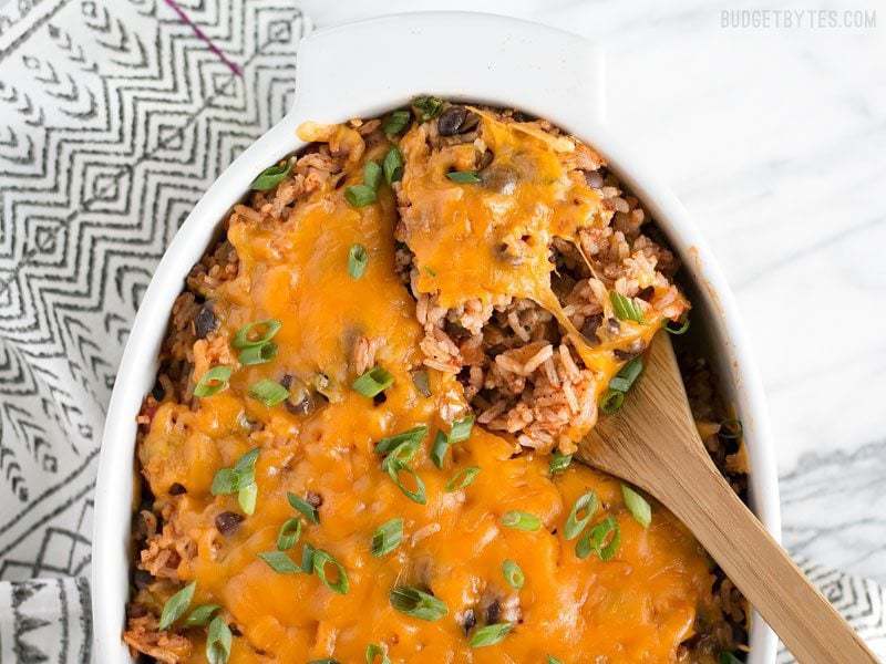 A spoonful of beef burrito casserole in a dish.