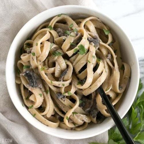 Creamy mushroom herb pasta served in a bowl.