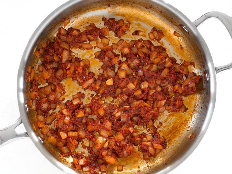 Diced Onion and Salt sautéed with the tomato and herbs in the skillet