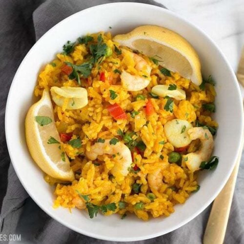 Seafood rice skillet served in a bowl with a fork.