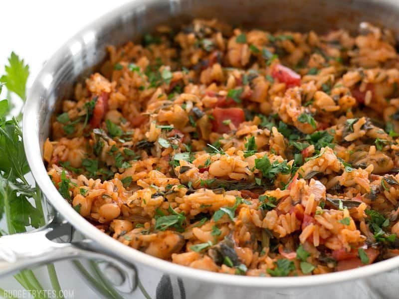 Side view of Tomato Herb Rice with White Beans and Spinach in the skillet