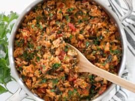 Tomato Herb Rice with White Beans and Spinach is a hearty and flavorful vegan dinner that will be loved by meat eaters and vegetarians alike. BudgetBytes.com