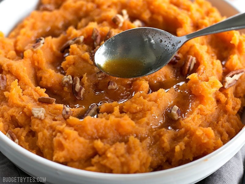 Close up of Brown Butter being drizzled onto Mashed Sweet Potatoes.