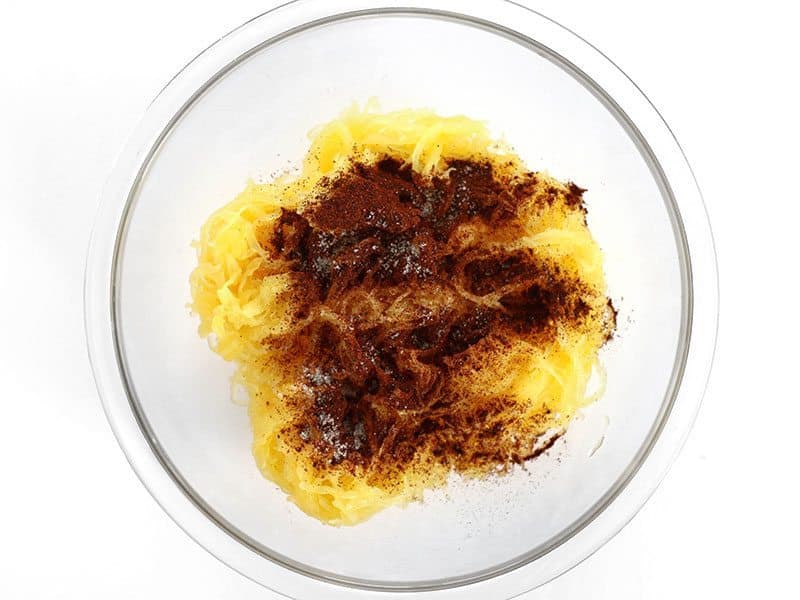 Seasoning added to Spaghetti Squash in a glass bowl