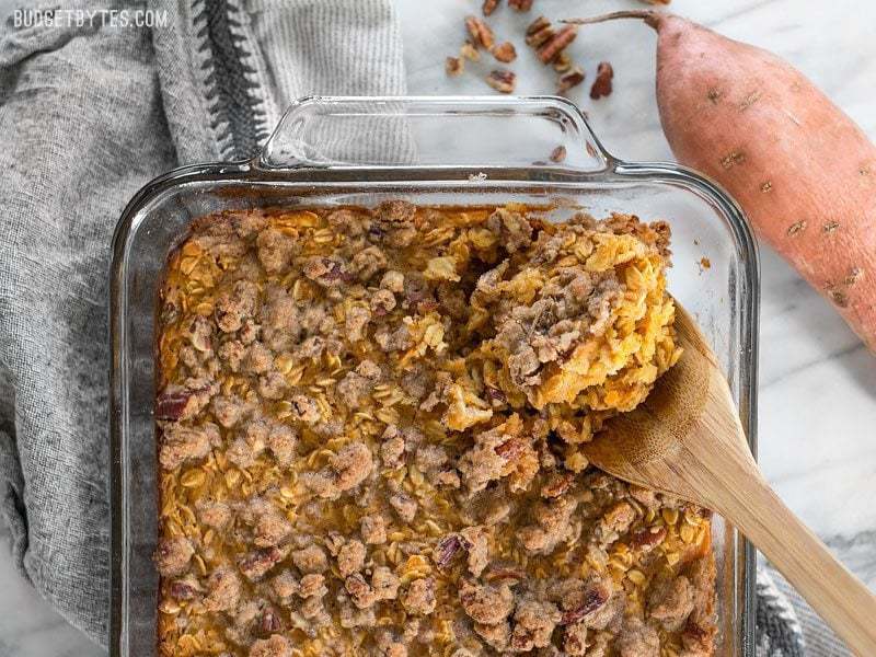 Sweet potato casserole baked oatmeal in a bowl being scooped.