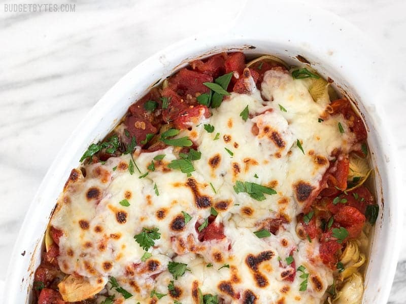 Overhead view of Baked Chicken with Artichokes and Tomatoes in the casserole dish