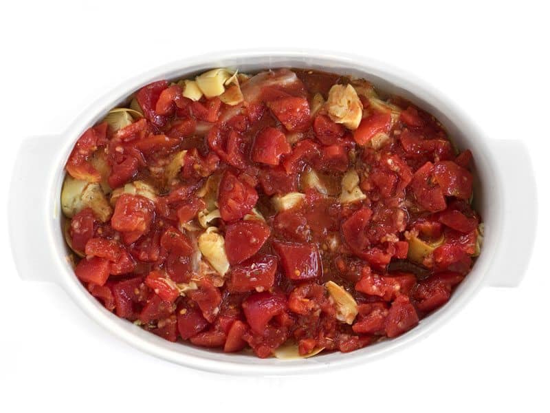 Diced Tomato mixture poured over Chicken in the casserole dish