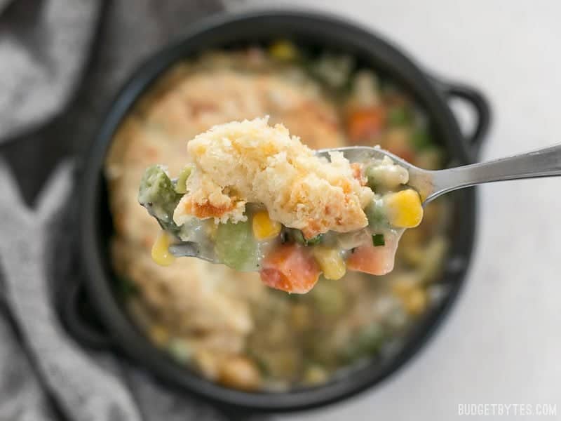 A forkful of warm and comforting Vegetable Pot Pie Skillet and Cheddar Biscuit