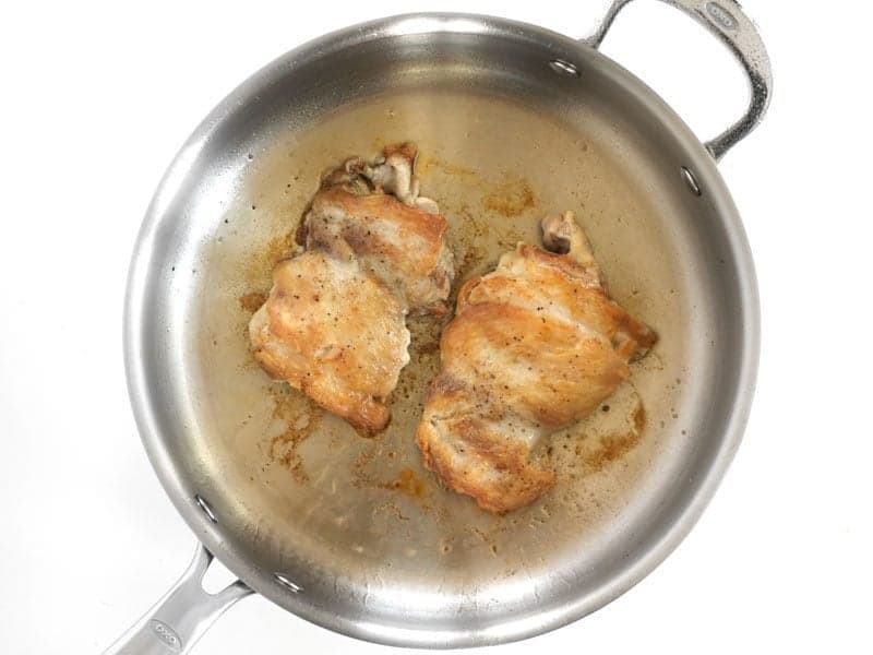 Browned Chicken Thighs in the skillet