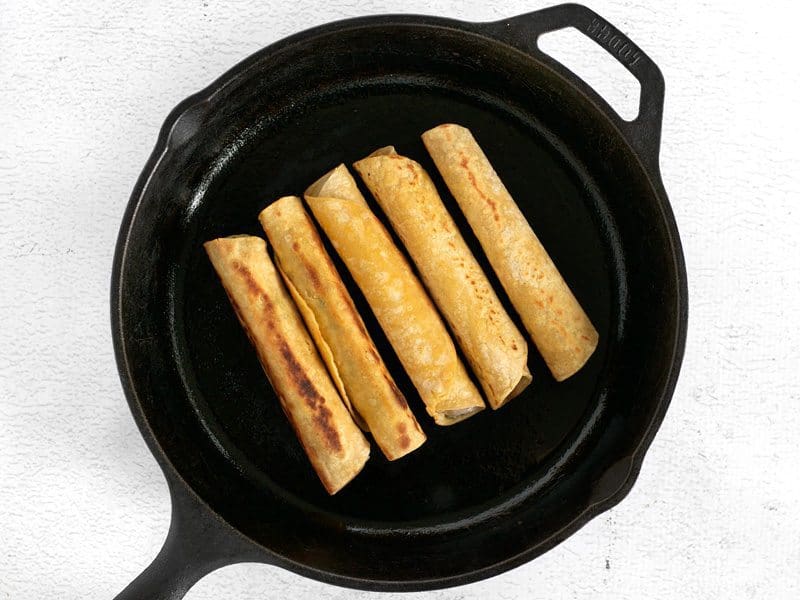 Cooking Taquitos in a cast iron skillet