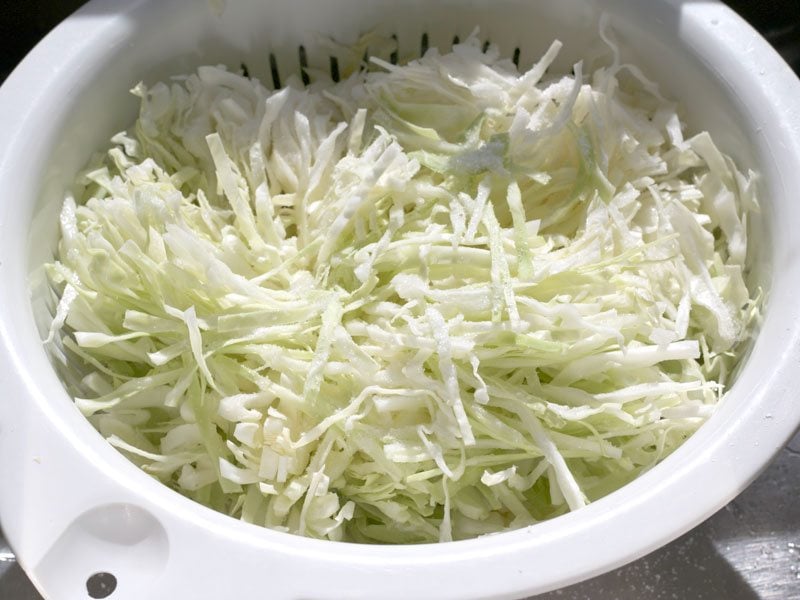 Salted Shredded Cabbage in a colander