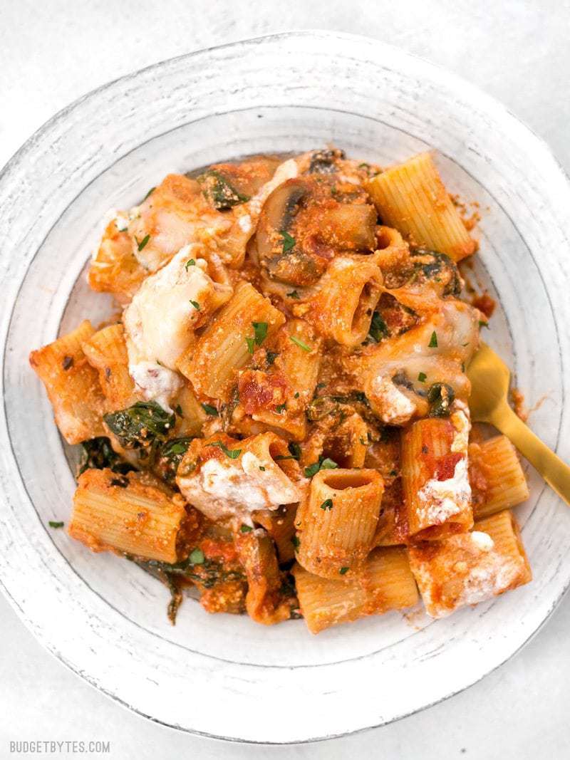 Cheesy Rigatoni Skillet served on a white plate with a gold fork