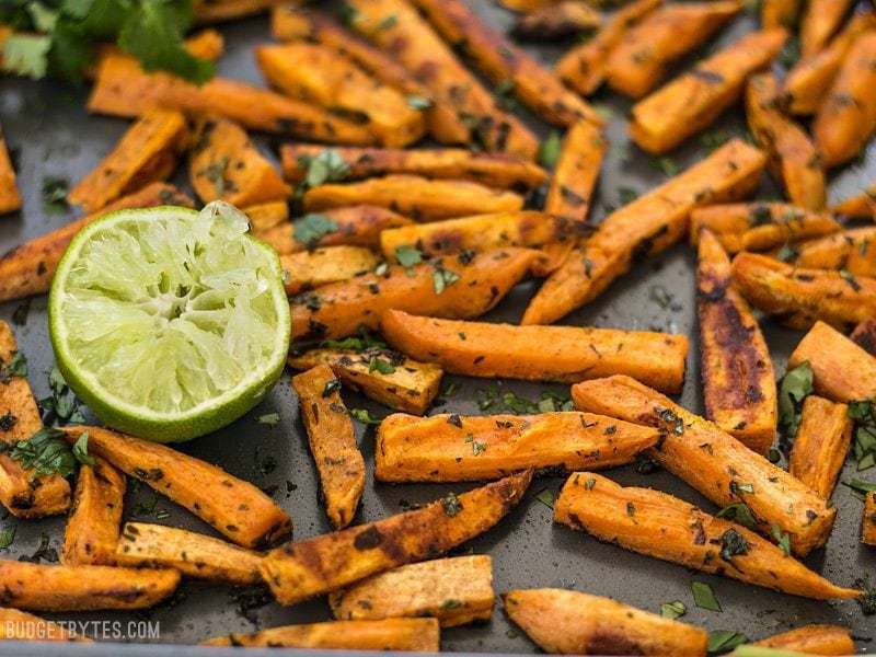 Close up side view of Cumin Lime Roasted Sweet Potatoes on the baking sheet