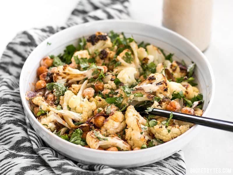 Front view of a stirred bowl of Roasted Cauliflower Salad 