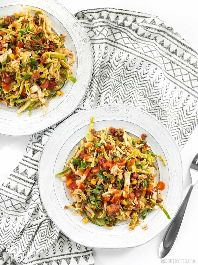 Two plates of Southwest Beef and Cabbage Stir Fry on a patterned napkin