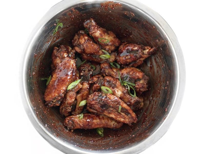 Wings Tossed in Glaze, topped with sliced green onions