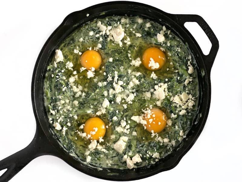 Raw eggs added to creamed spinach, topped with crumbled feta