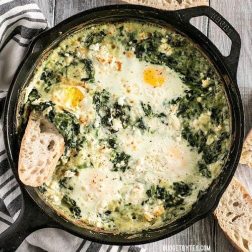 Make these fast and easy Creamed Spinach Baked Eggs using items you probably have in your pantry. A little feta on top takes it to the next level! BudgetBytes.com