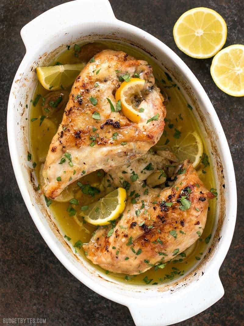 Finished Lemon Garlic Roasted Chicken garnished with fresh lemon slices and parsley