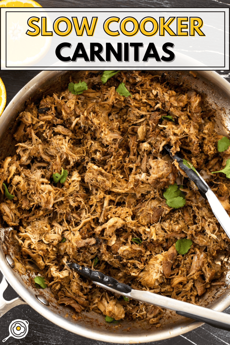 Overhead view of slow cooker carnitas in a skillet with tongs.