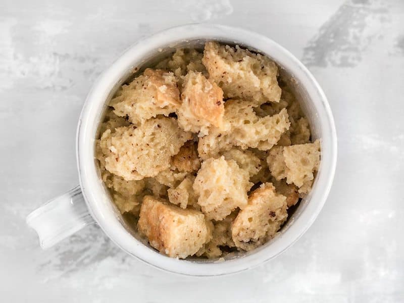 Stir bread chunks into wet ingredients in mug