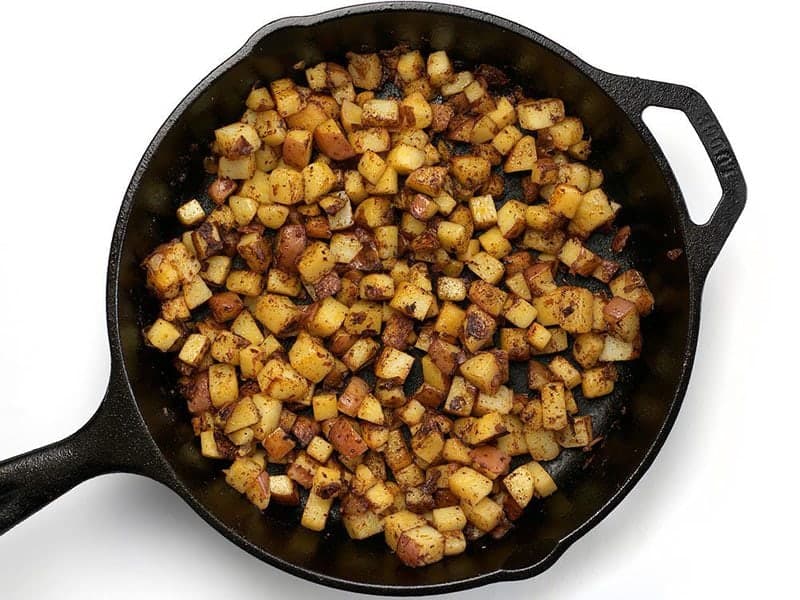 Fried Potatoes and Chili Powder in the cast iron skillet