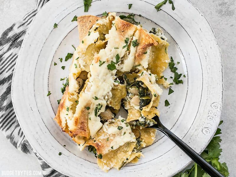 Spinach White Bean Enchiladas served on a plate with a black fork