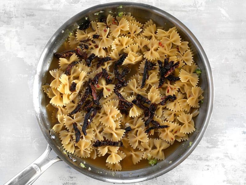 Add Pasta, Broth, and Tomatoes to the skillet