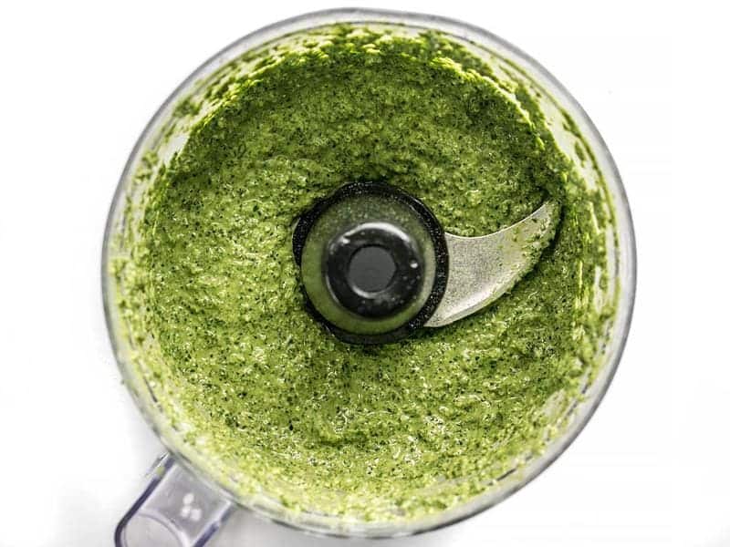 Pureed homemade kale pesto in the food processor bowl